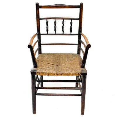 Lot 213 - A stained beech elbow chair.