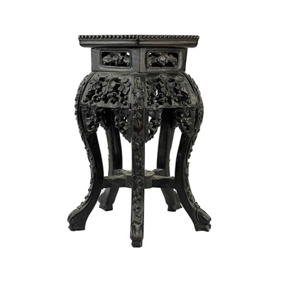 Lot 164 - A Chinese carved hardwood jardiniere stand, 19th century.