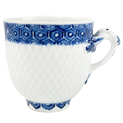 Lot 575 - An unusual Bow scale moulded and blue painted porcelain coffee cup.