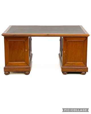 Lot 615 - A teak partners desk.