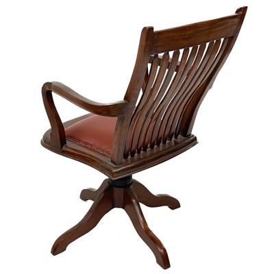 Lot 603 - A teak swivel office chair.