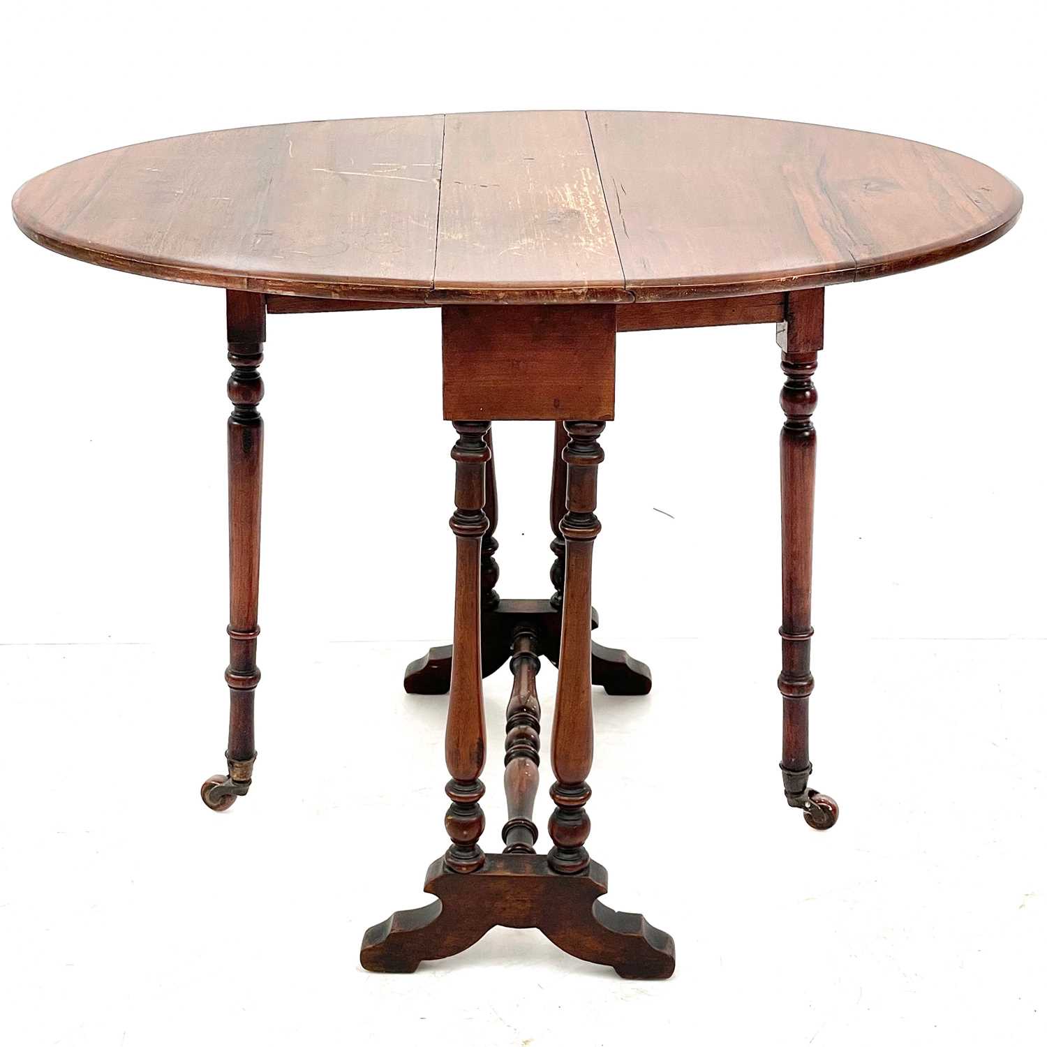 Lot 692 - A late Victorian small oval walnut drop leaf Sutherland table.