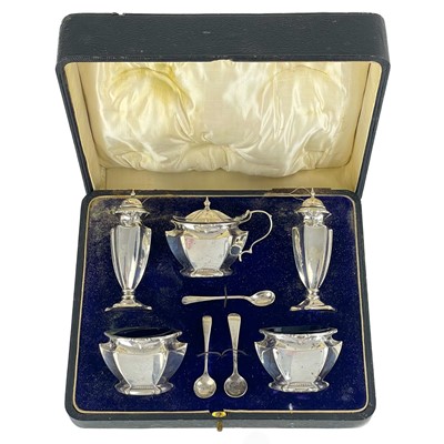 Lot 30 - A George V Art Nouveau silver cased set of five cruets by John Rose.