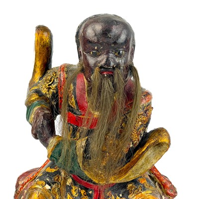 Lot 119 - A Chinese carved giltwood and painted figure of Fa Zhu Gong, 19th century.