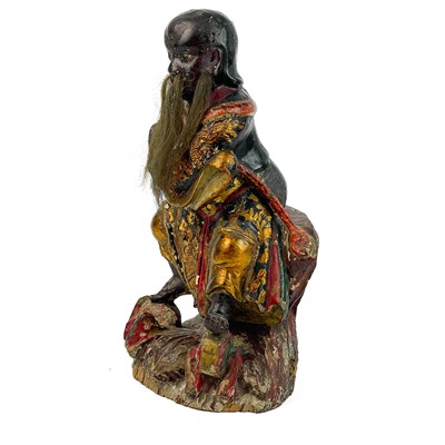Lot 119 - A Chinese carved giltwood and painted figure of Fa Zhu Gong, 19th century.