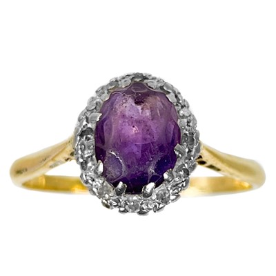 Lot 63 - An 18ct and platinum amethyst and diamond set cluster ring.