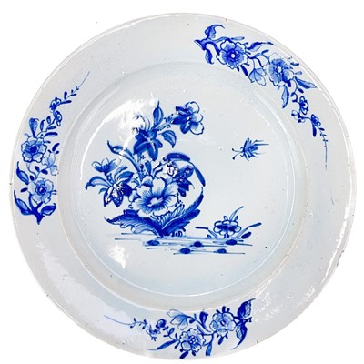 Lot 410 - A Lowestoft plate with blue and white floral and insect decoration.