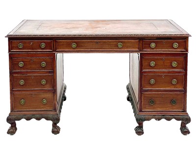 Lot 692 - A Georgian style mahogany twin pedestal free standing writing desk.