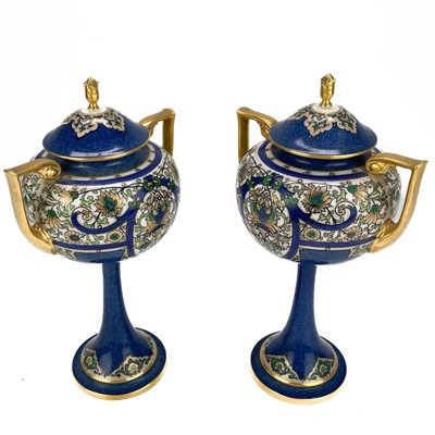 Lot 513 - A pair of Royal Worcester porcelain twin handled stem vases and cover.