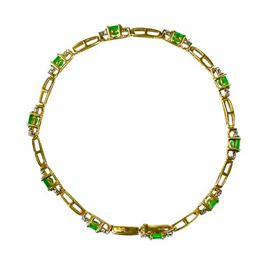 Lot 103 - A modern 9ct gold diamond and emerald set bracelet.