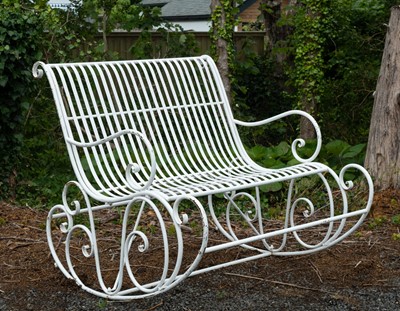 Lot 369 - A wrought iron two seater garden rocking chair.