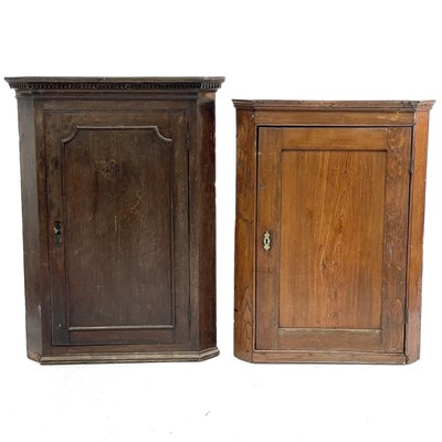 Lot 630 - A George III elm corner cupboard.