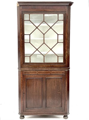 Lot 393 - A George III oak glazed corner cupboard.