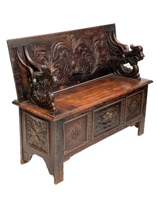 Lot 101 - A late Victorian carved oak monk's bench.