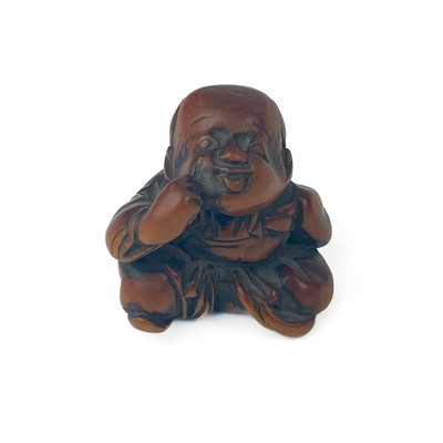 Lot 1280 - A Japanese wooden netsuke of a seated boy, 19th century.