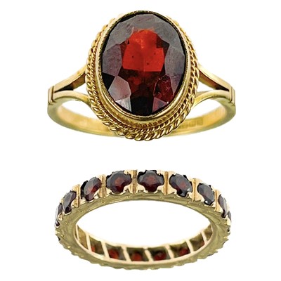 Lot 122 - A 9ct garnet set eternity ring and a 9ct garnet set single stone ring.