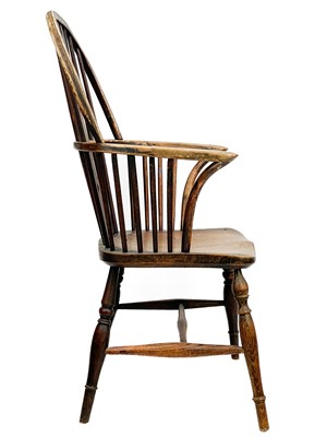 Lot 246 - An ash and fruitwood wheelback Windsor armchair.