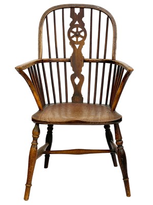 Lot 246 - An ash and fruitwood wheelback Windsor armchair.