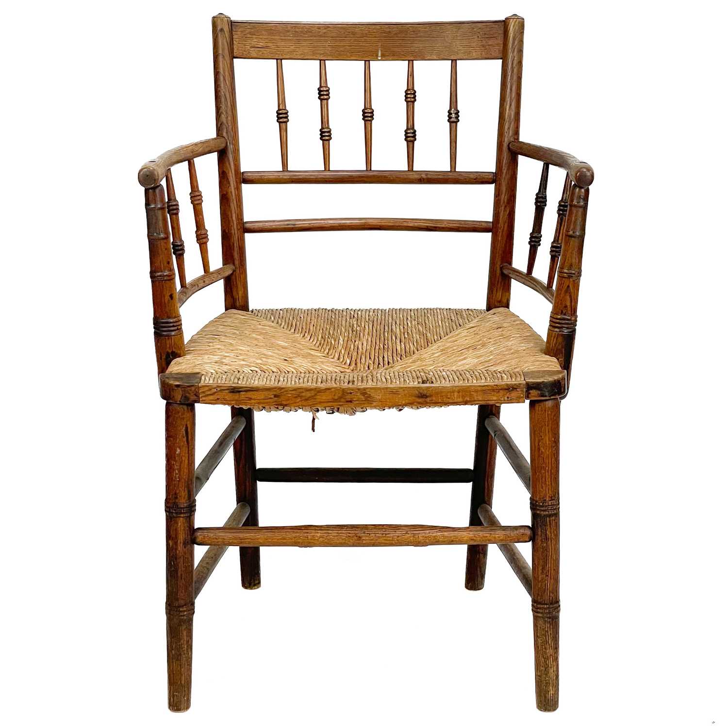 Lot 22 A Victorian ash spindle back elbow chair.