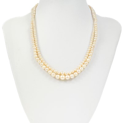 Lot 136 - An early 20th century two strand graduated pearl necklace with diamond 9ct clasp.