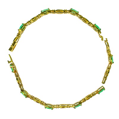 Lot 164 - A modern 9ct gold diamond and emerald set bracelet.