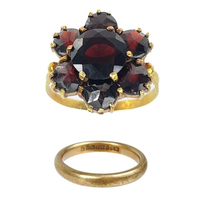 Lot 177 - A 9ct band ring and a gold garnet set seven stone cluster ring.