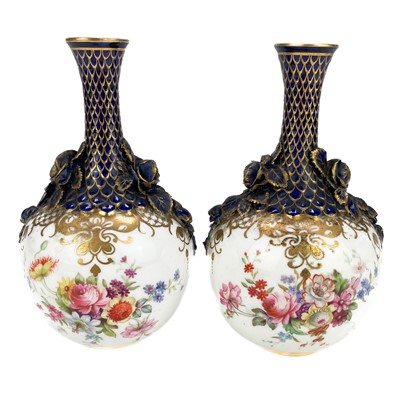 Lot 441 - A pair of Royal Worcester bottle vases with moulded floral and scale design highlighted in gilt.