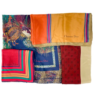 Lot 628 - Christian Dior - four vintage printed silk scarves.