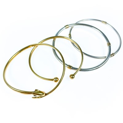 Lot 198 - Two 9ct gold bangles and two silver gold mounted bangles.