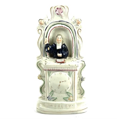 Lot 128 - A Victorian Staffordshire flatback clock group of Wesley in the pulpit.