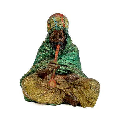 Lot 132 - A cold painted bronze model of a seated Arab smoking a pipe.