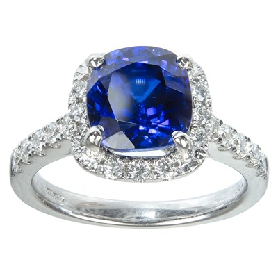 Lot 242 - An 18ct white gold, 2ct (approx) blue sapphire and diamond cluster ring.