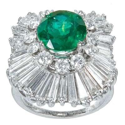 Lot 140 - A dazzling 18ct white gold,  4ct (approx) emerald and diamond cluster dress ring.