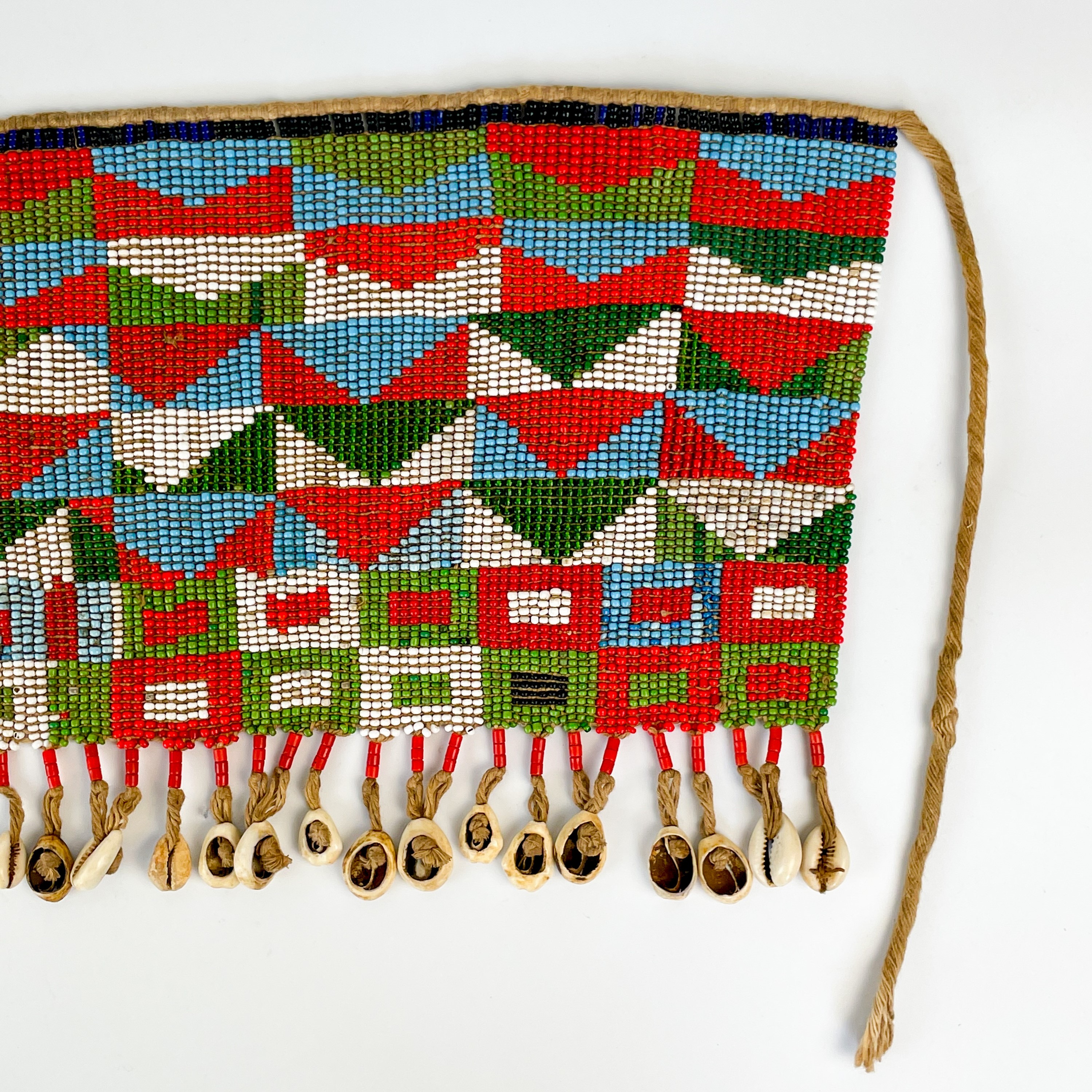 Lot 157 - An Angolan beadwork and cowrie shell apron,