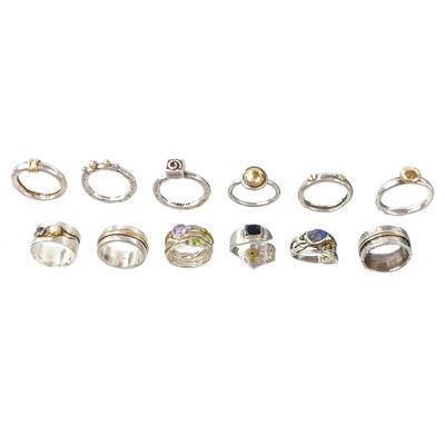 Lot 491 - A selection of twelve stylish and heavy silver and yellow metal rings.