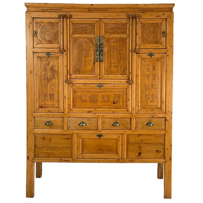 Lot 1199 - A large Chinese carved elm cabinet, early 20th century.