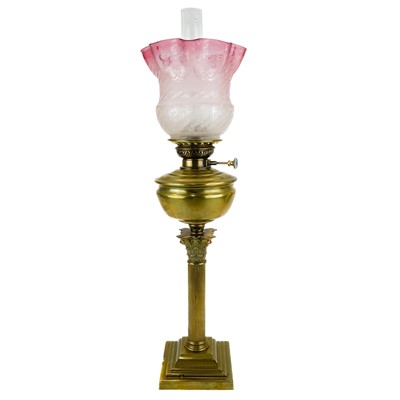 Lot 251 - A Victorian brass oil lamp with an etched cranberry glass shade.