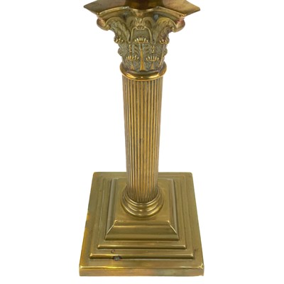 Lot 251 - A Victorian brass oil lamp with an etched cranberry glass shade.