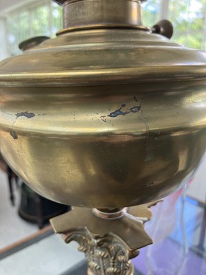 Lot 251 - A Victorian brass oil lamp with an etched cranberry glass shade.