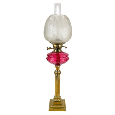 Lot 202 - A Victorian brass oil lamp with glass shade.