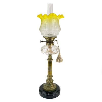 Lot 158 - A Victorian brass oil lamp with a glass reservoir and etched yellow shade.