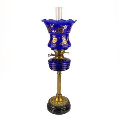 Lot 152 - A Victorian brass oil lamp with a blue glass oil reservoir and blue glass shade.