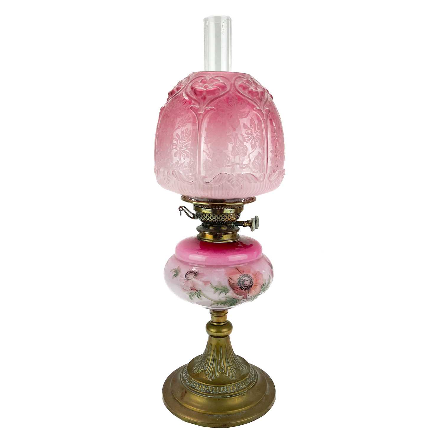 Lot 190 - A Victorian brass oil lamp with a pink glass reservoir and cranberry shade.