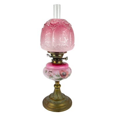 Lot 190 - A Victorian brass oil lamp with a pink glass reservoir and cranberry shade.