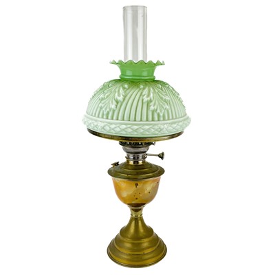 Lot 44 - A Victorian brass oil lamp with a moulded green glass shade.