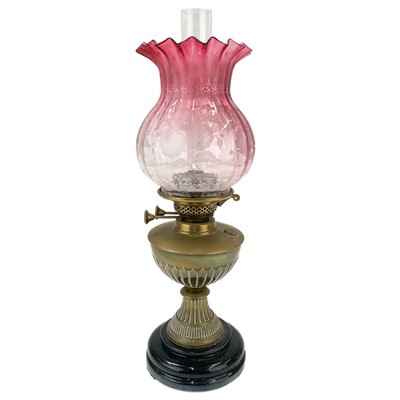 Lot 54 - A Victorian brass oil lamp with cranberry etched glass shade.