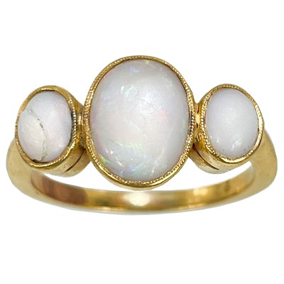 Lot 275 - An early 20th century high purity gold (tests 22ct) opal set three stone ring.