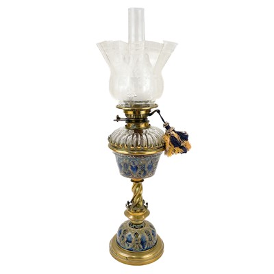 Lot 176 - A Victorian brass oil lamp with a ceramic and glass oil reservoir and clear glass shade.