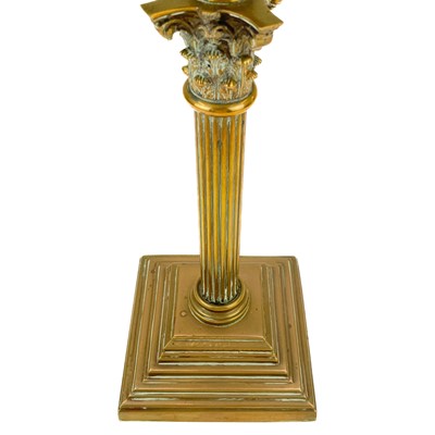 Lot 21 - A Victorian brass oil lamp with a clear glass oil reservoir and white glass shade.