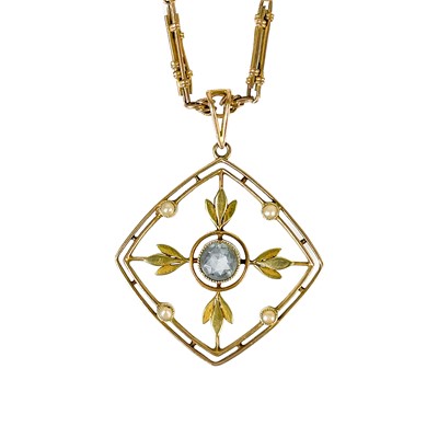 Lot 285 - An Edwardian 15ct aquamarine and pearl set open-work pendant on a fancy link chain.